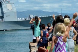 Friends and family members of sailors wave as the guided-missile cruiser USS Lake Erie returned to Joint Base Pearl Harbor-Hickam on Monday from a four-month Western Pacific deployment. (U.S. Navy photo by Mass Communication Specialist 2nd Class Laurie Dexter)