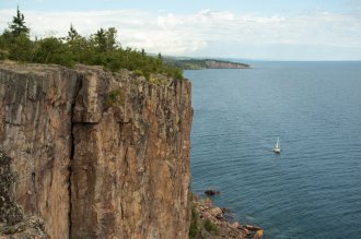The Freeman's sailing past Palisade Head on north shore of Lake Superior during their journey by water from the Boundary Waters to Washington DC. Photo by: Nate Ptacek @arborealis